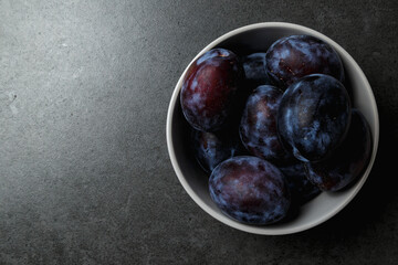 Fresh plums. Fruits. On a dark background. Top view. Copy space.