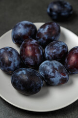 Fresh plums. Fruits. On a dark background. Copy space.