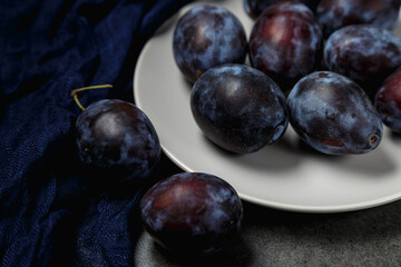 Fresh plums. Fruits. On a dark background. Copy space.
