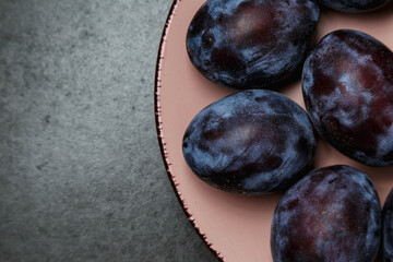 Fresh plums. Fruits. On a dark background. Copy space.