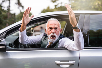 Angry senior man  arguing after car accident.