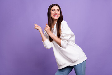 Photo of young cheerful positive happy enjoy charming woman look empty space dance isolated on purple color background