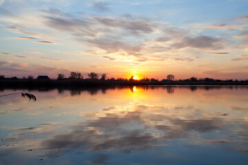 Beautiful sunset perfectly reflected in the waters of the river.