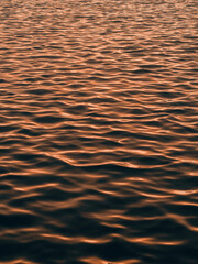 waves on the water surface during sunset