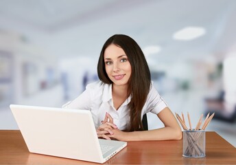 Fototapeta premium Beautiful businesswoman working with laptop computer at a desk in the office.