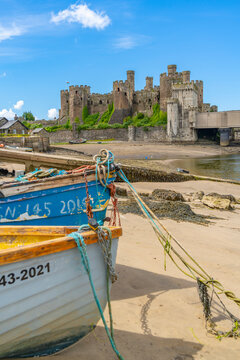 View of Conwy Castle, UNESCO World Heritage Site, and boats on the shore, Conwy, Conway County Borough, Wales