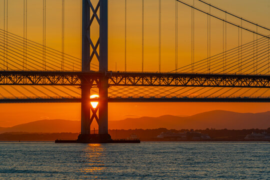 View of the Forth Road Bridge and Queensferry Crossing over the Firth of Forth at sunset, South Queensferry, Lothian
