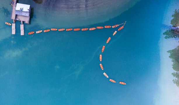 Rowing boats moored in Lake Braies (Pragser Wildsee) from above, Dolomites, South Tyrol