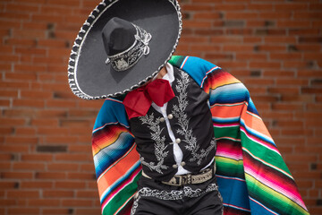 Mexican charro dancer with sombrero and multicolored serape from jalisco mexico with mariachi music