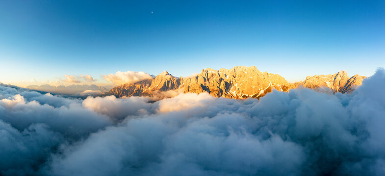 Aerial view of Popera group, Cima Undici and Croda Rossa di Sesto rock peaks emerging from clouds, Dolomites, South Tyrol