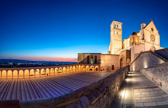 Panoramic of the illuminated arcade and Basilica di San Francesco during blue hour, UNESCO World Heritage Site, Assisi, Perugia province, Umbria