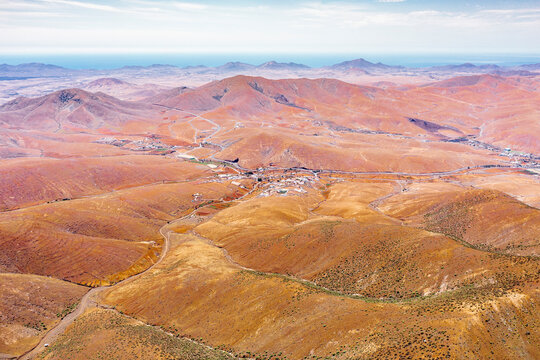 Winding road in the desert landscape from Mirador del Risco de las Penas viewpoint, Pajara, Fuerteventura, Canary Islands
