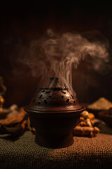 Burning incense in a traditional pottery pot