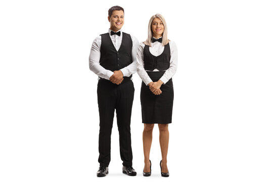 Full length portrait of a waiter and waitress posing and smiling