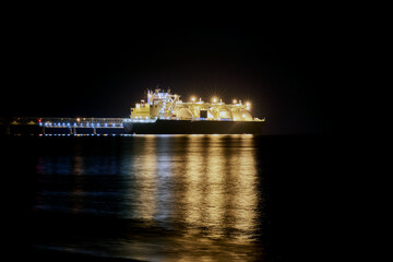 Fototapeta premium Gas carrier at night against the background of dark sea.