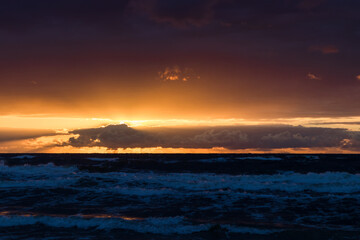 A beautiful, romantic and colorful sunset at the Polish seaside, the Baltic Sea. Beautiful beach and the sun setting in the colorful sky
