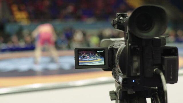Cameraman with a camera in wrestling competitions.