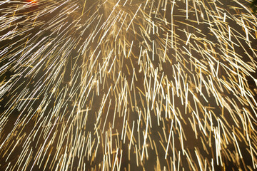 Thousands of fireworks falling from everywhere on black background.