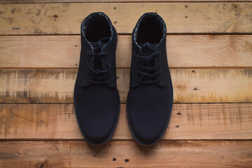 A pair of blue shoes on wood.
