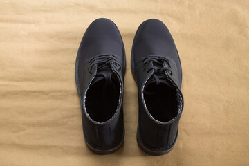 A pair of blue shoes on a brown background.