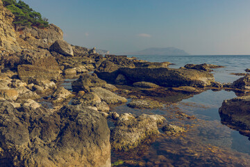 Stony Crimean coast in autumn. Crimea. Calm sea surface. you feel calm and peace of mind.