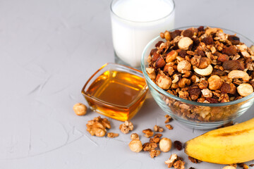 A crispy granola with rip banana and honey for breakfast. Healthy food concept. Сlose-up. Copy space.