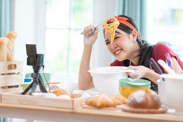 close up woman blogger making a bread, whisking cream in a bowl and recording stream live video online from camera