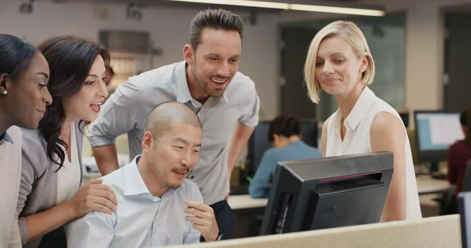 Creative business team meeting happy people working in modern office late at night discussing strategy using computer touch screen in diverse gender group