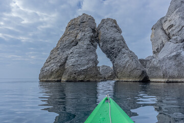 View from the nose of a green sea kayak on stones of the mount Karaul-Oba. Crimea. Novy Svet