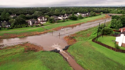Swift running water after hurricane Nicholas pouring into a bayou that is part of a massive flood control system protecting large residential areas.