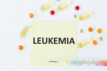 Card with text LEUKEMIA, pills and thermometer. Medical concept.