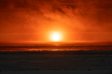 Beautiful sunset with fog in Arctic sea.