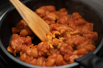 Close up of frying chicken wings