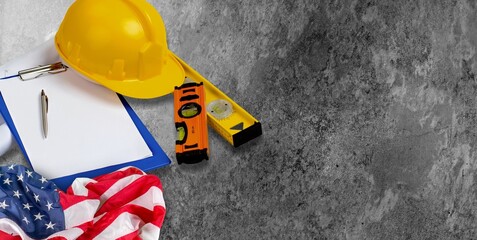 Happy Labor day concept. American flag with different construction tools