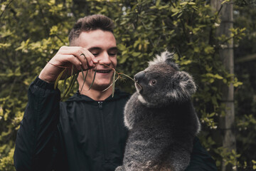 Homme portant un koala © adrien