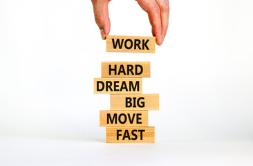 Work hard dream big symbol. Words Work hard dream big move fast on wooden blocks on a beautiful white background. Businessman hand. Business, motivational and work hard dream big move fast concept.
