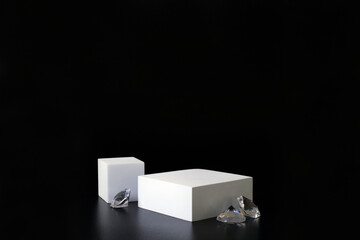 White podium on the black background with diamonds. Podium for product, cosmetic presentation....