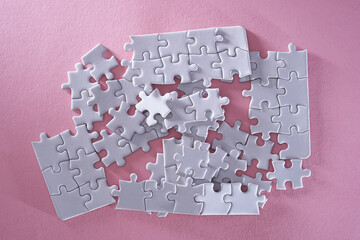 close up jigsaw puzzle on pink background