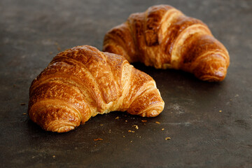 Croissant with butter two pieces on a black board. High quality photo