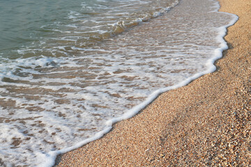 Beautiful seascape with waves and sea foam on shore