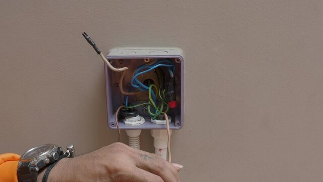 Electrical plug repairs and extension cords by a professional electrician. with equipment such as drills, wires, fuses, floating boxes and conduit wiring. installing wall switches and sockets.
