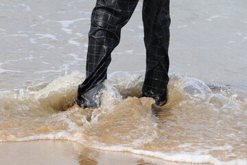 man jumping in water near pondichurry Beach 
