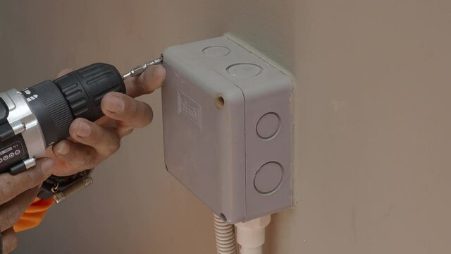 Electrical plug repairs and extension cords by a professional electrician. with equipment such as drills, wires, fuses, floating boxes and conduit wiring. installing wall switches and sockets.