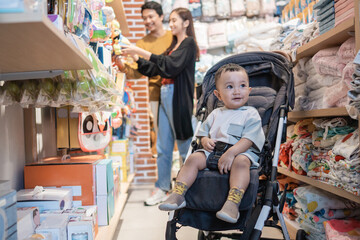 family with child shopping a product in the baby shop