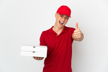 Pizza delivery man with work uniform picking up pizza boxes isolated on white background with thumbs up because something good has happened