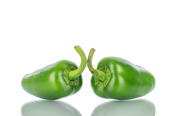 Two green spicy pepper pods, close-up, isolated on white.