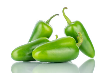 Several green spicy pepper pods, close-up, isolated on white.