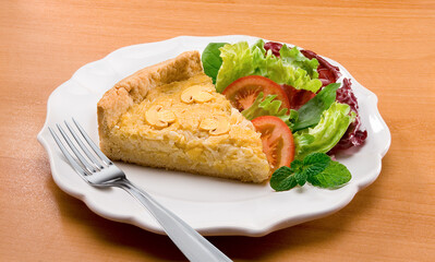 Torta de champignons com salada no prato no fundo de mesa decorada.