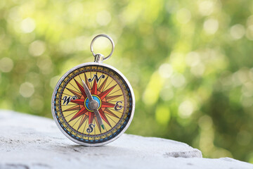 round compass on natural wooden background as symbol of tourism with compass, travel with compass and outdoor activities with compass