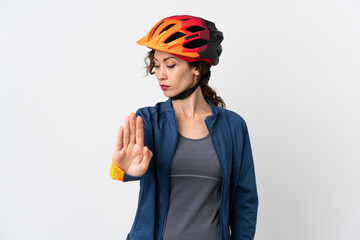 Young cyclist woman isolated on white background making stop gesture and disappointed